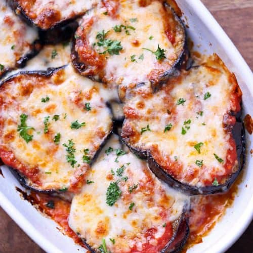 Eggplant casserole served in a white baking dish.