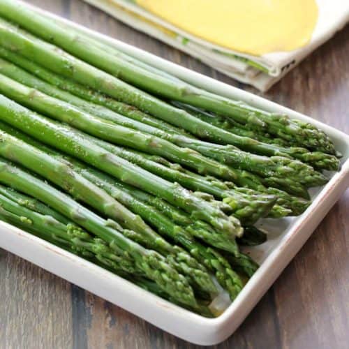 Steamed asparagus served on a serving platter.