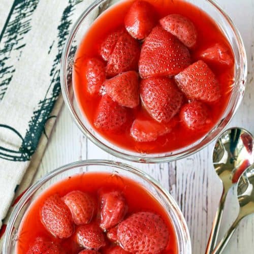 Strawberry compote served in dessert glasses with spoons.