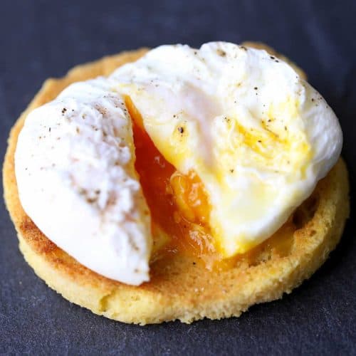Poached egg, cut open and served on a slice of toast.