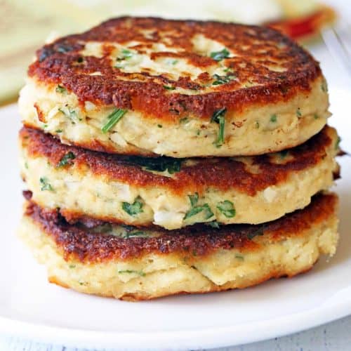 Turkey patties stacked on a white plate.