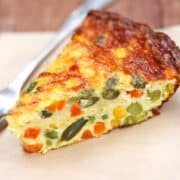 Crustless vegetable quiche served with a fork.