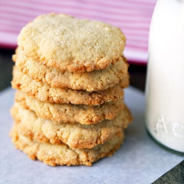 Keto shortbread cookies, stacked, served with milk.