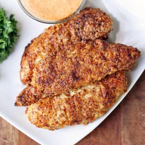Almond flour chicken tenders served with a dip.