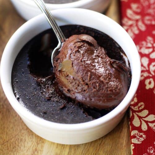 Chocolate custard served with a silver spoon.
