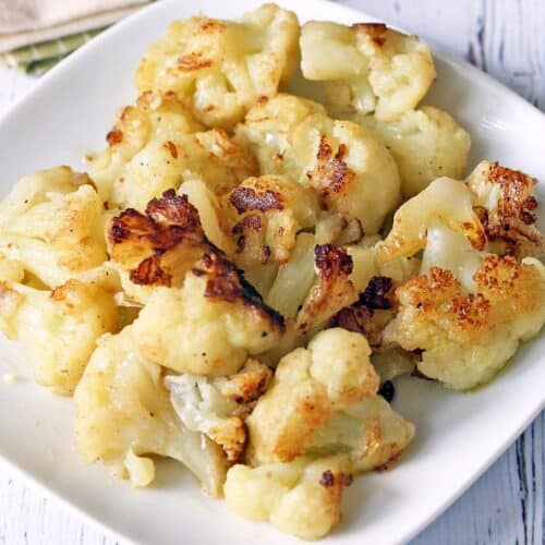 Sauteed cauliflower served on a white plate.