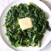 Sauteed spinach topped with butter.