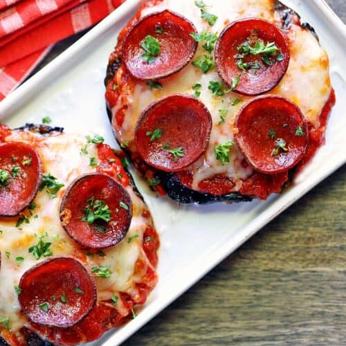 Portobello pizza served on a white platter with a napkin.