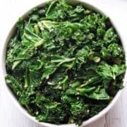 Sauteed kale served in a white bowl.