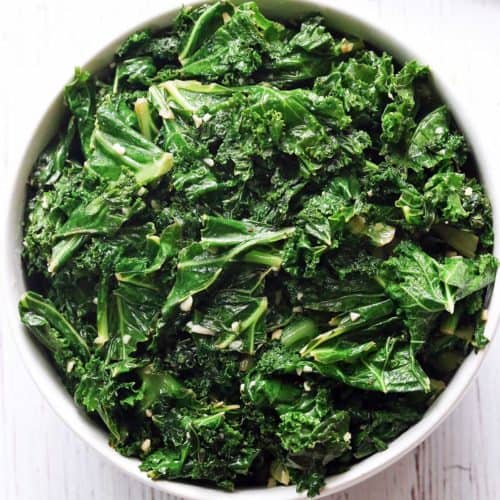 Sauteed kale served in a white bowl.