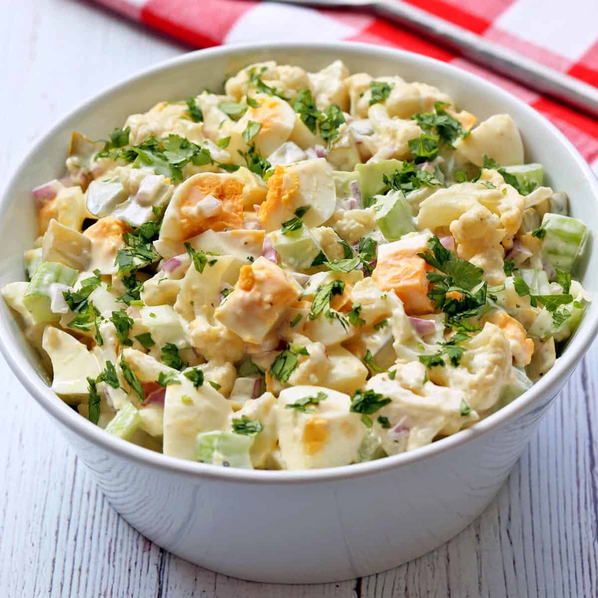 Cauliflower potato salad served in a white bowl.