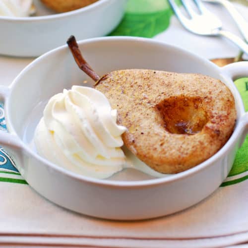 Baked pears served with whipped cream.