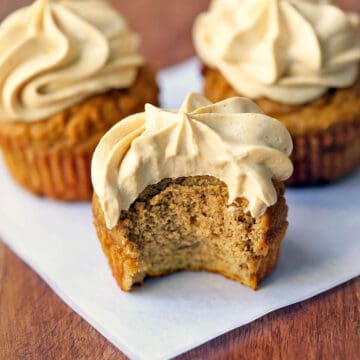 Keto pumpkin cupcakes topped with frosting.