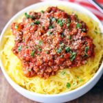 Spaghetti squash with meat sauce served in a white bowl.