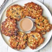 Cabbage pancakes served with a dipping sauce.