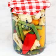 Quick pickles are stored in a glass jar.