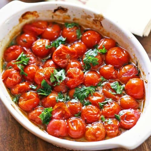 Roasted cherry tomatoes in a baking dish.