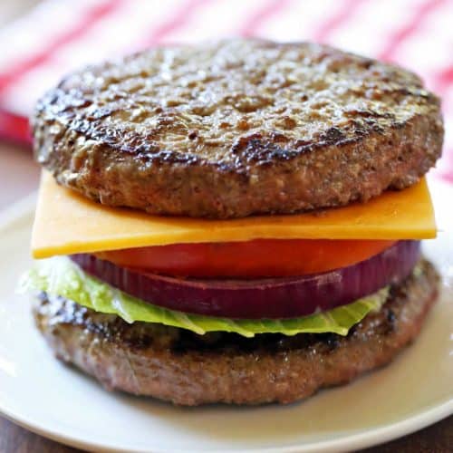 Bunless burger with cheese, onion, lettuce, and tomato.