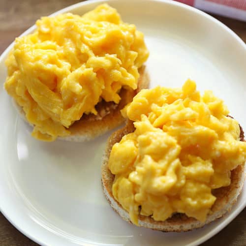 Soft-scrambled eggs served on bread slices.