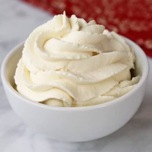 Sugar-free keto whipped cream served in a white bowl.