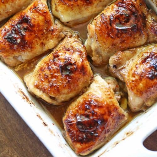 Soy sauce chicken served in a white baking dish.