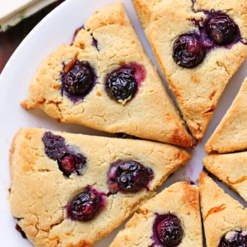 Keto scones with blueberries served on a white plate.