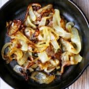 Sauteed onions in a cast-iron skillet.