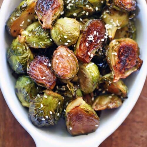 Asian Brussels sprouts served in a white baking dish.