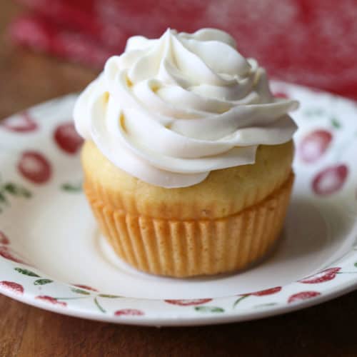 Keto cream cheese frosting is shown on top of a cupcake.