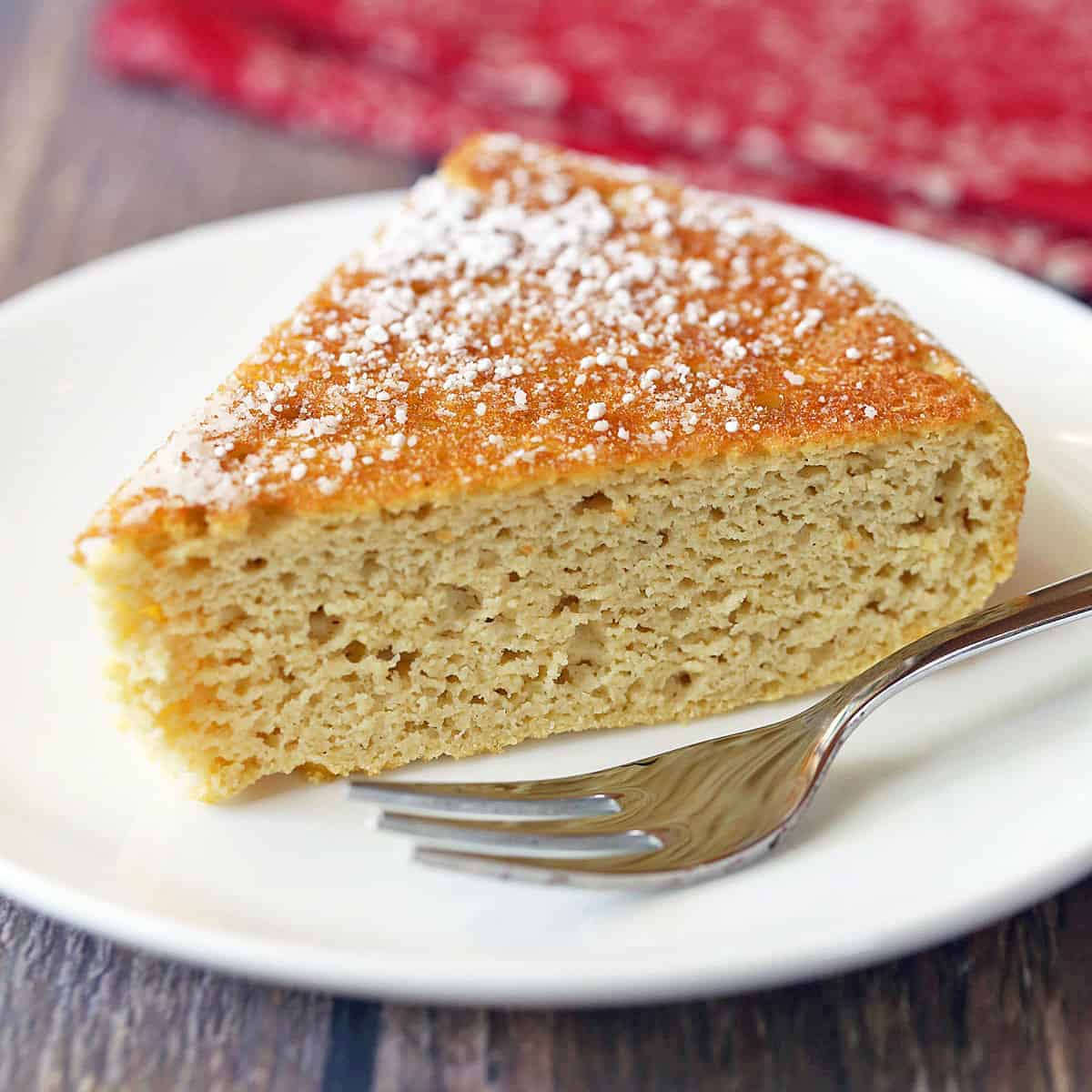 Coconut flour cake served on a plate with a fork.