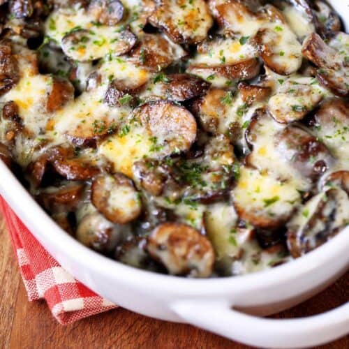 Mushroom casserole served in a white baking dish with a napkin.