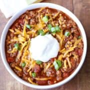 No bean chili is topped with a dollop of sour cream.