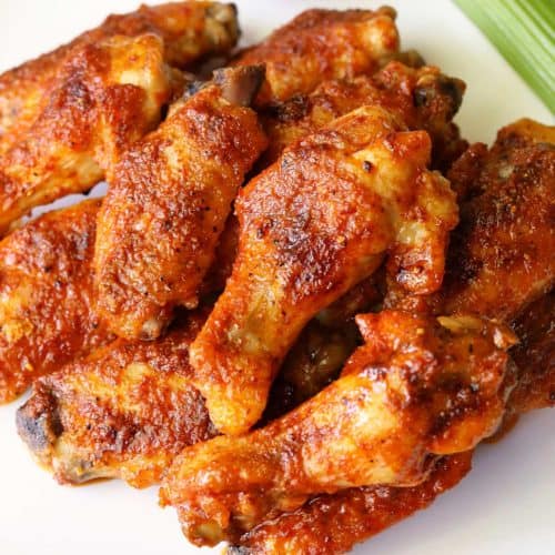 Buffalo wings served with celery.