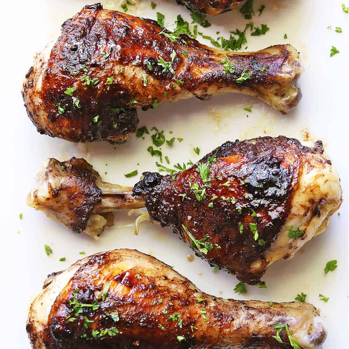 Jerk chicken served on a white plate.