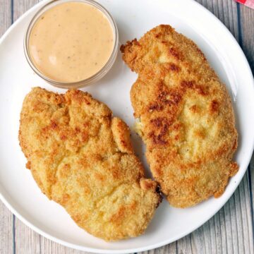 Gluten-free chicken tenders served with a dipping sauce.