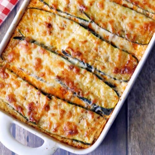 Zucchini lasagna is served in a white baking dish.