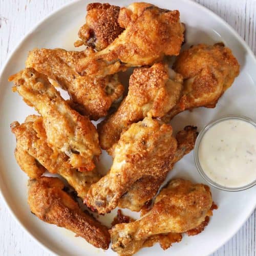 Garlic parmesan wings served with a dipping sauce.
