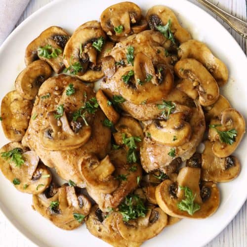 Chicken and mushrooms topped with chopped parsley.