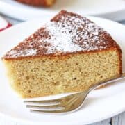 Almond flour cake served on a white plate with a fork.
