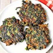 Spinach fritters served on a white plate.