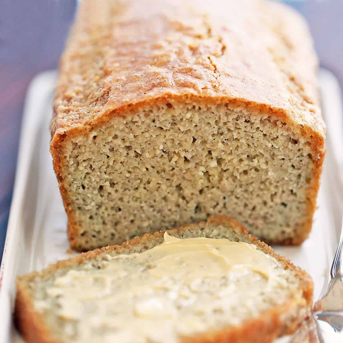 Almond flour bread is served on a white serving tray.