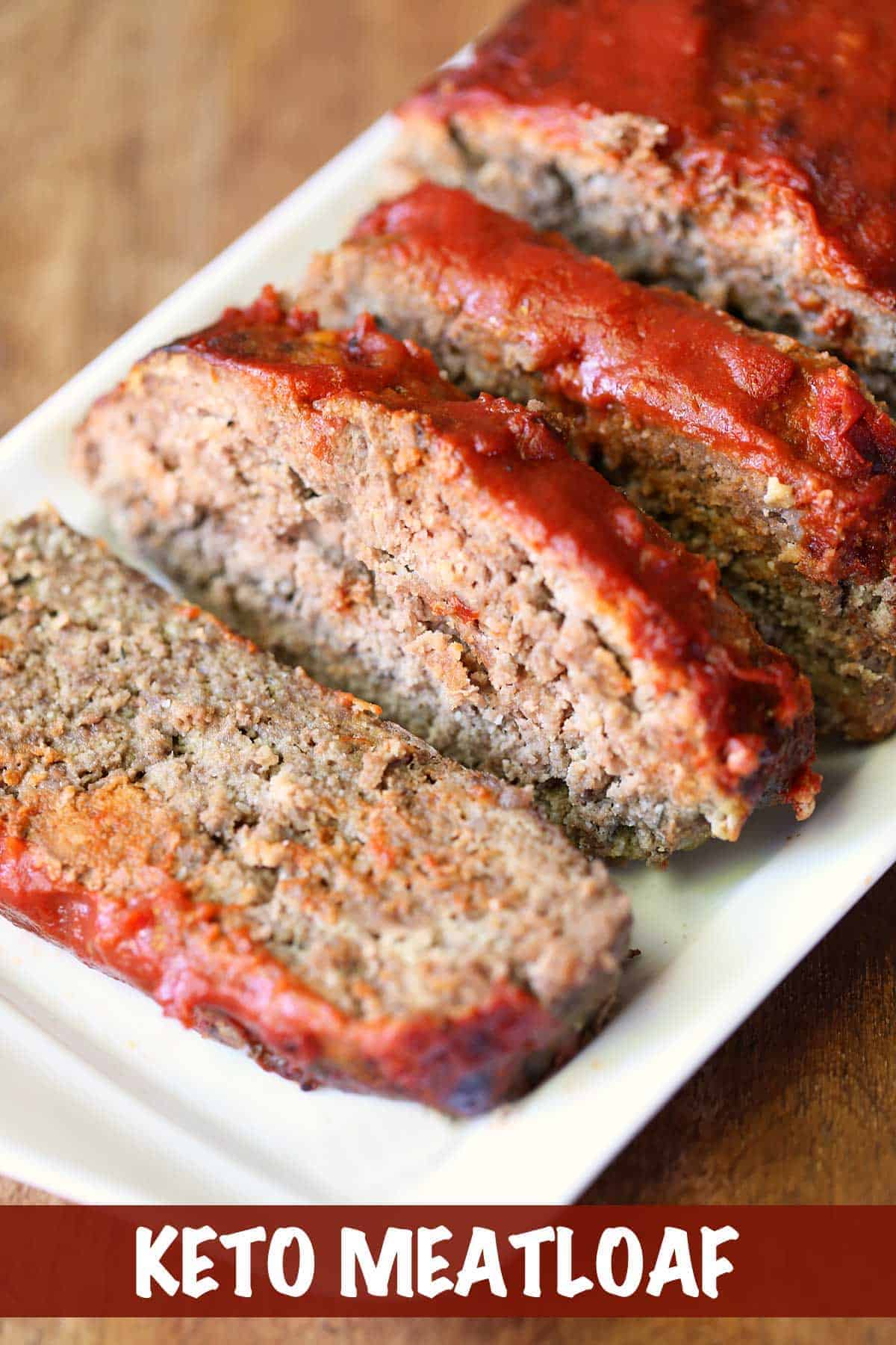 Keto meatloaf, sliced and served on a white serving tray.