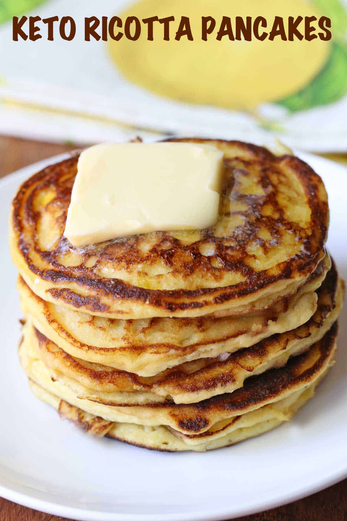 Keto ricotta pancakes topped with butter. 