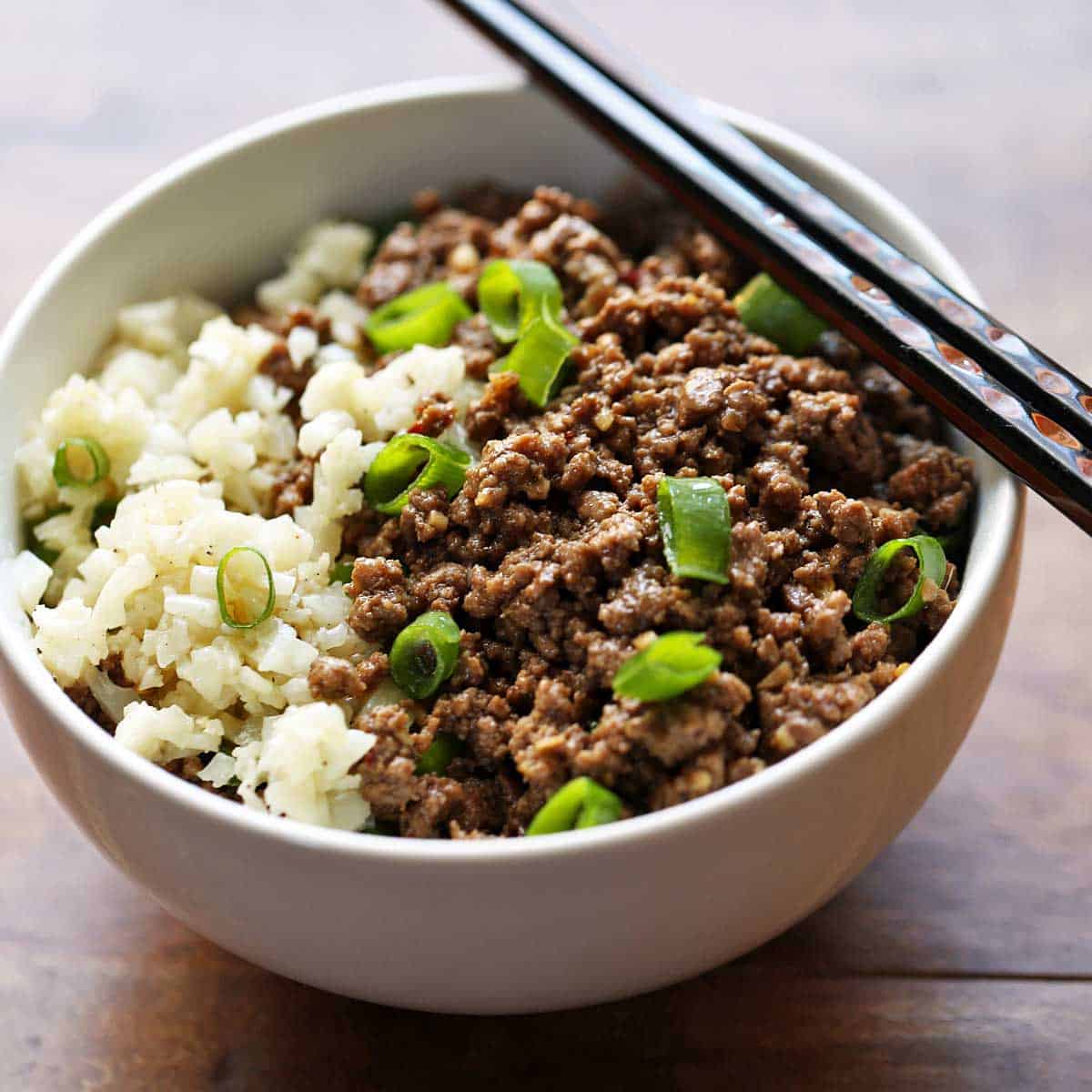Korean ground beef is served in a bowl with chopsticks.