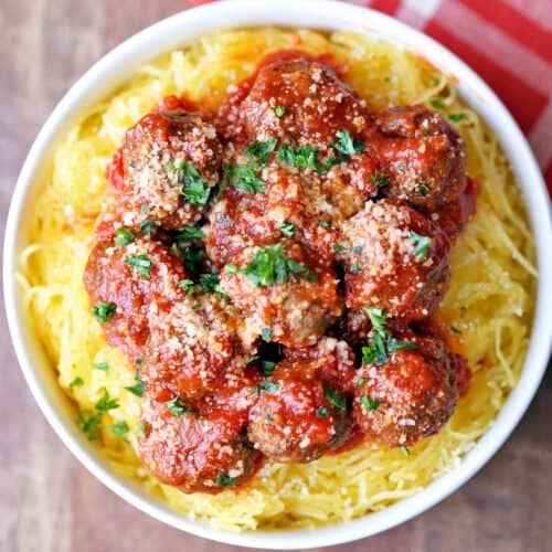 Spaghetti squash and meatballs served in a white bowl.