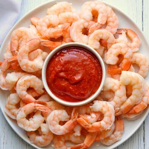 Boiled shrimp served with cocktail sauce.