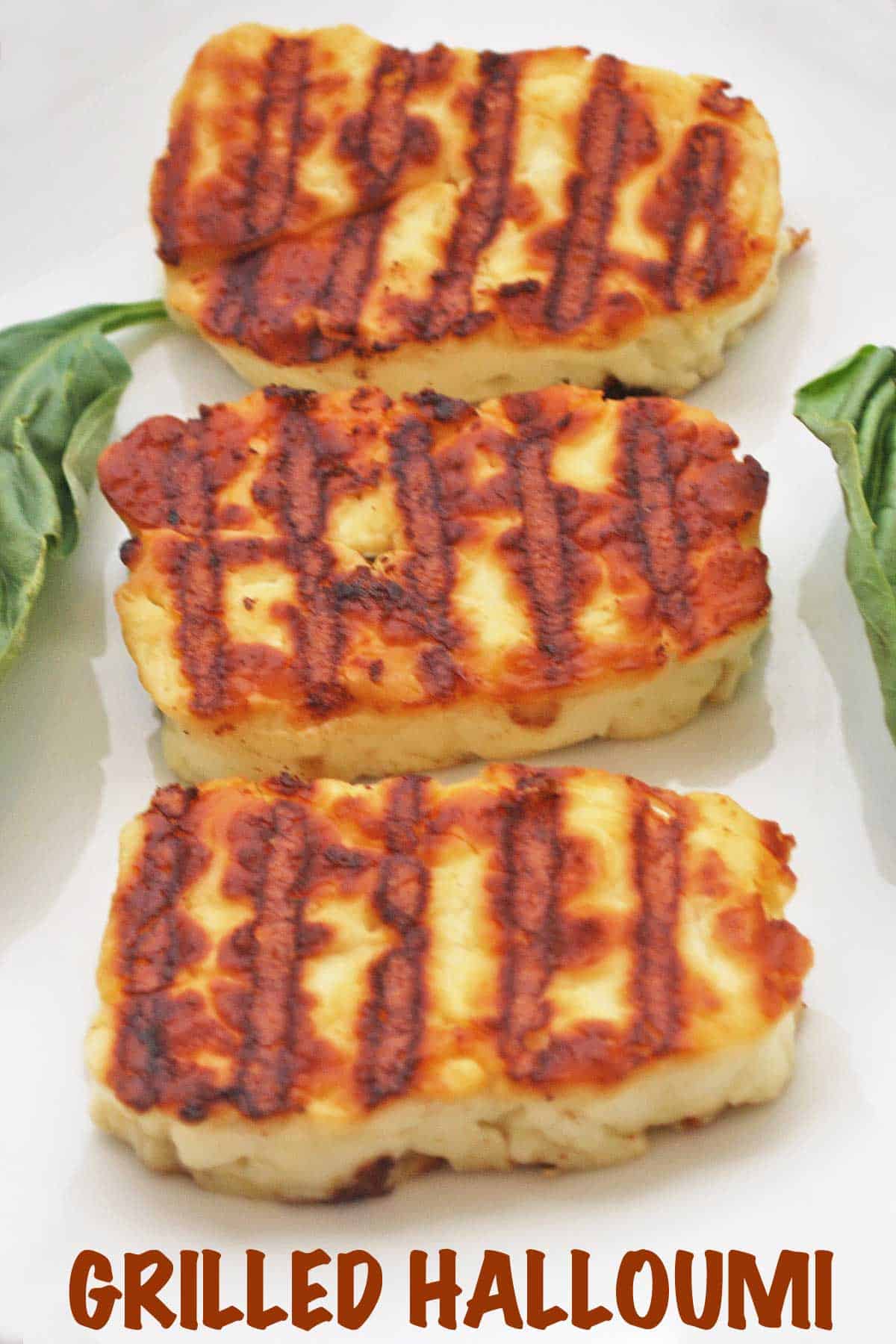 Grilled halloumi cheese slices on a plate.
