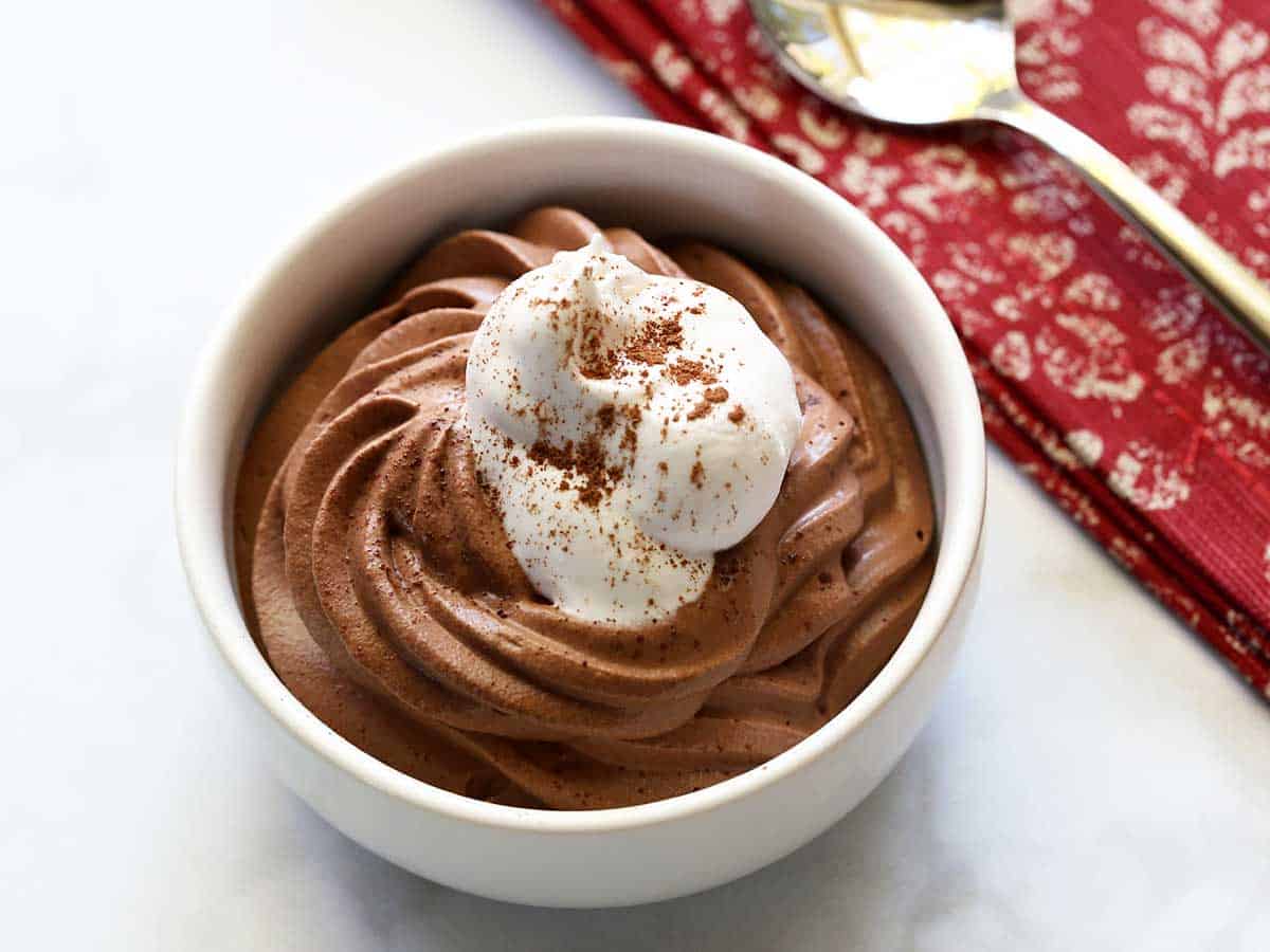 Keto chocolate mousse topped with whipped cream. 