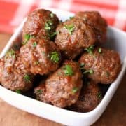 Baked meatballs without breadcrumbs served in a white bowl.