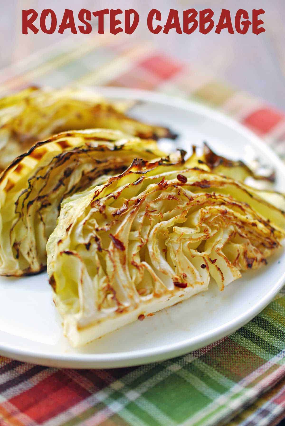 Roasted cabbage served on a white plate. 